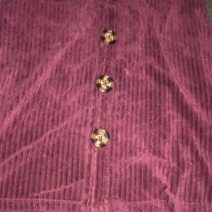 I’m sealing a soft lined purple dress with buttons.